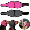 Pink and black noise cancelling dog ear wraps shown on a dog's head.