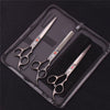 A professional stainless steel pet grooming scissors set laid out in a black zippered pouch.