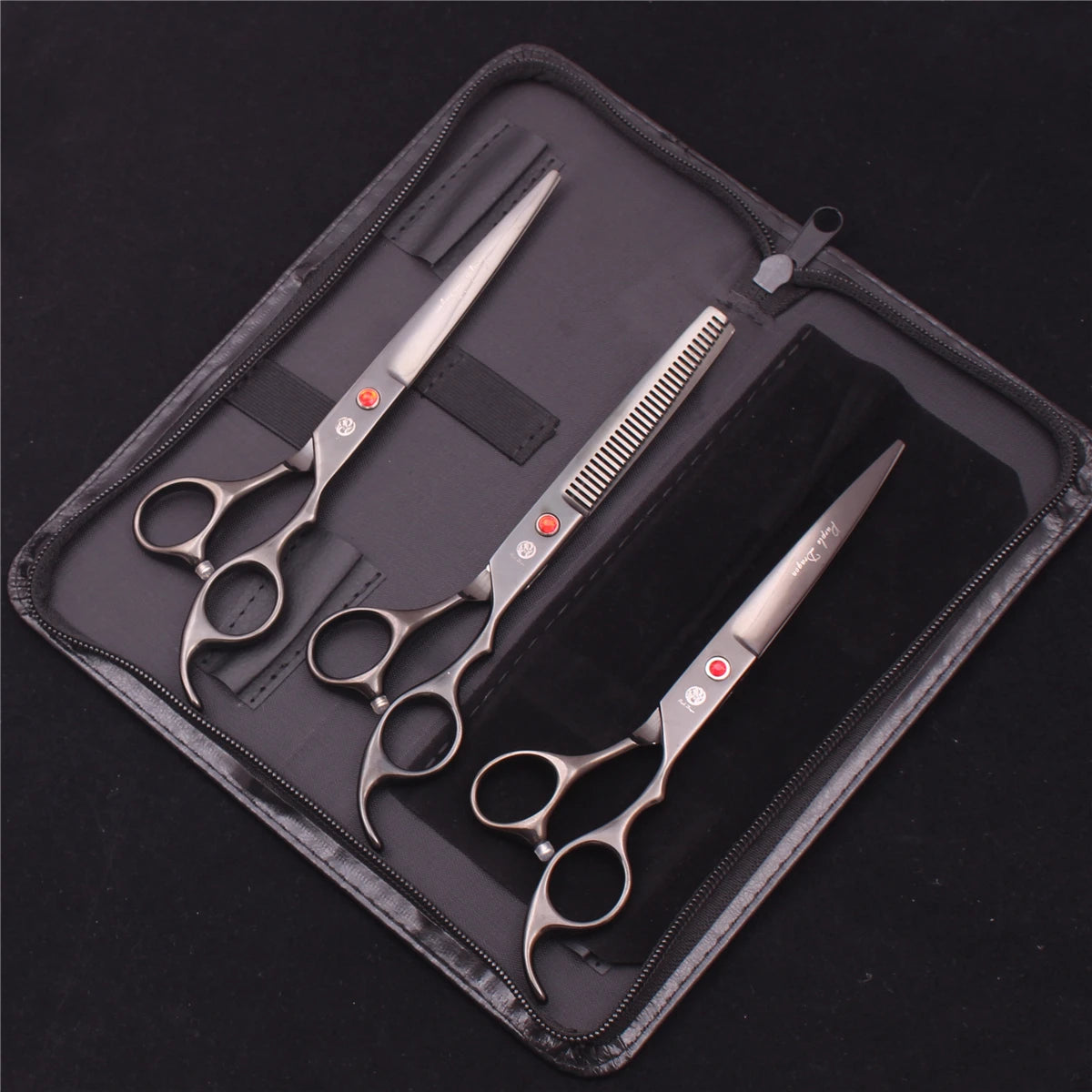 A professional stainless steel pet grooming scissors set laid out in a black zippered pouch.