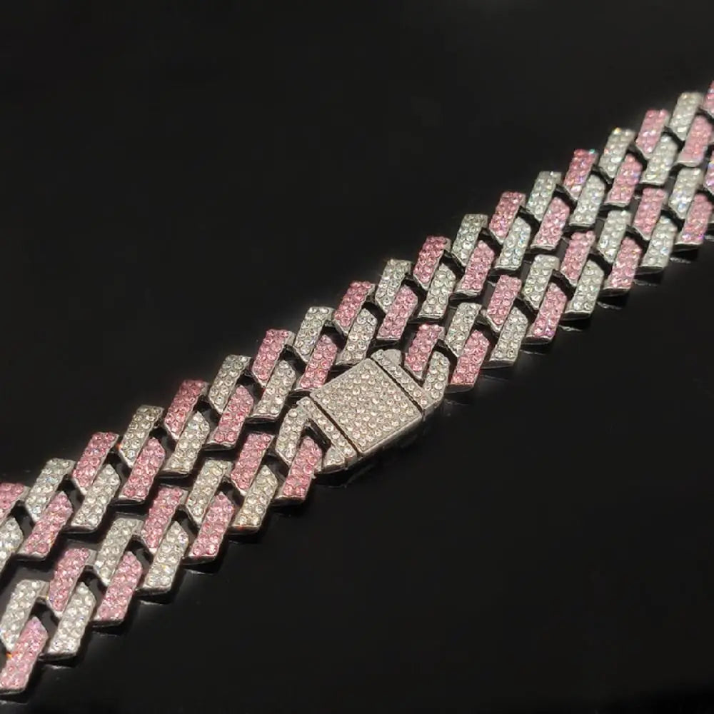 A close-up of a diamond link pet collar for dogs featuring pink and white diamonds.