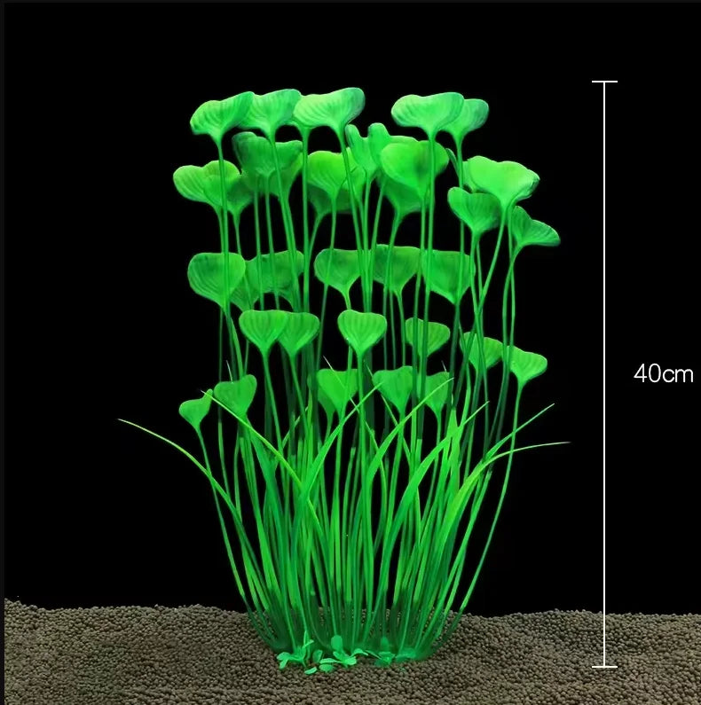 A clump of bright green artificial aquarium plants growing in sand.