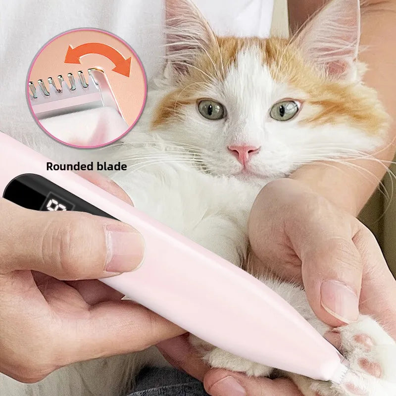 A cat is being groomed with a pink rounded blade pet hair trimmer, showing the grooming tool and its usage.