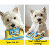A fluffy white dog is interacting with a blue and yellow snuffle toy puzzle for dogs.