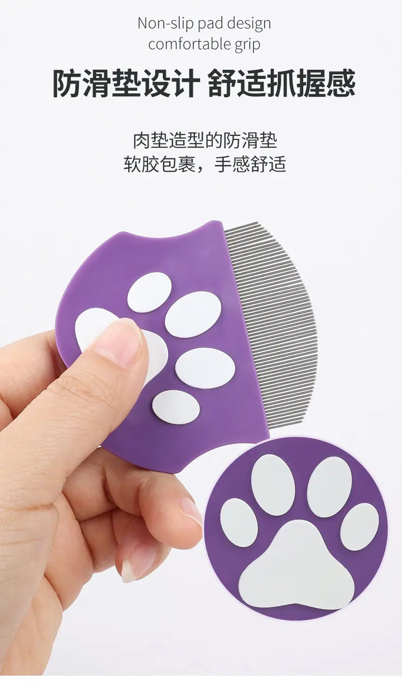A purple mini pet grooming comb with non-slip pad design and a white paw shape is held by a hand.