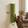 A tabby cat is climbing a vertical, cylindrical green scratching post mounted on a wall.