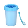 A light blue silicone pet paw cleaner container with a blue silicone brush and a blue cord.