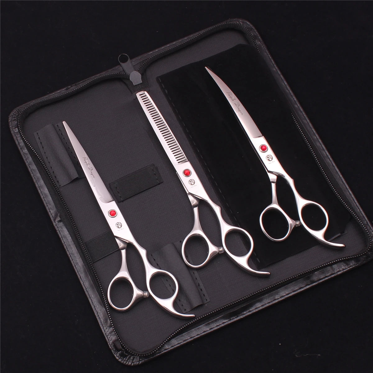 A professional stainless steel pet grooming scissors set displayed in a black leather case.