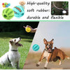 A dog is playing with a green rubber ball, demonstrating the durable and flexible nature of the treat-dispensing toy.
