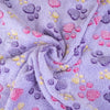 A soft lavender fleece blanket featuring a pattern of purple and pink paw prints.