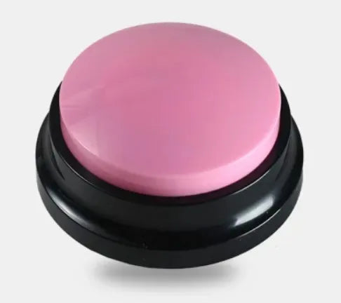 A round, pink talking pet training button with a black base.