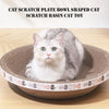A fluffy gray and white cat is sitting inside a round, bowl-shaped corrugated scratching pad toy.