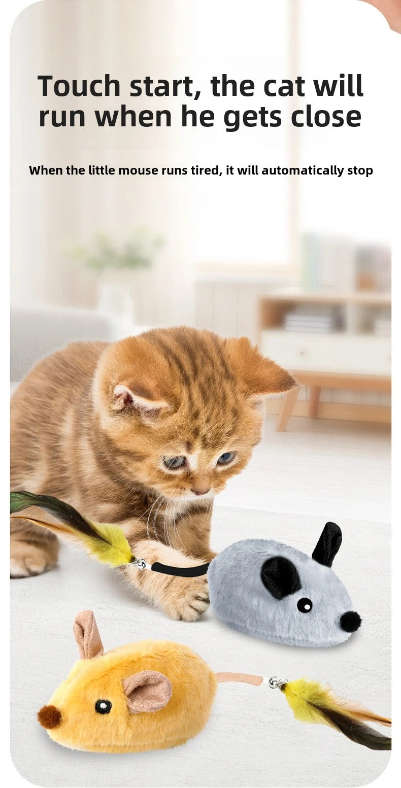 A small orange kitten is interacting with a toy mouse, demonstrating the motion-activated feature.