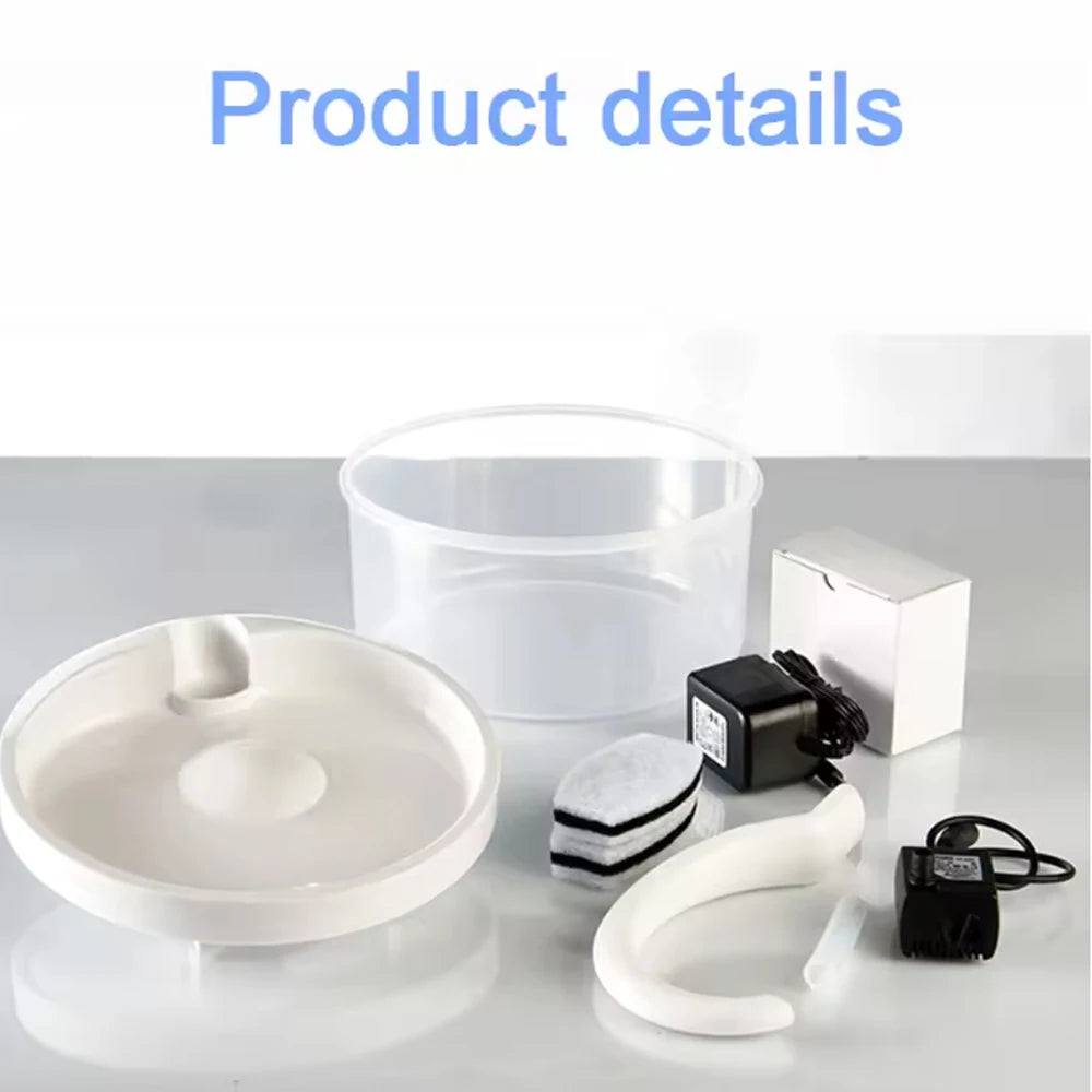 A white pet water fountain and related accessories including a bowl, power unit, and tubing are displayed on a white surface.
