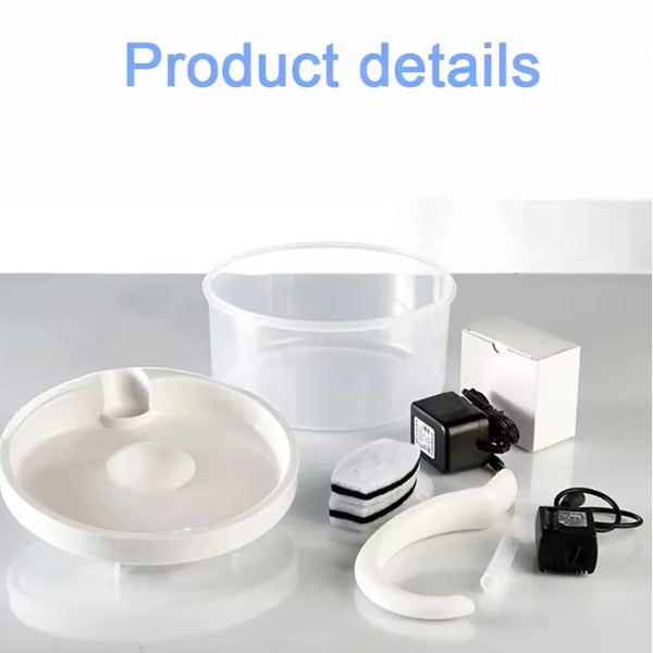 A white pet water fountain and related accessories including a bowl, power unit, and tubing are displayed on a white surface.