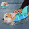 A hand is using a rescue handle on a turquoise dog life jacket for dogs in the water.