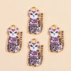 A collection of gold-colored cat and animal pendant charms featuring purple, black, and white stripes.