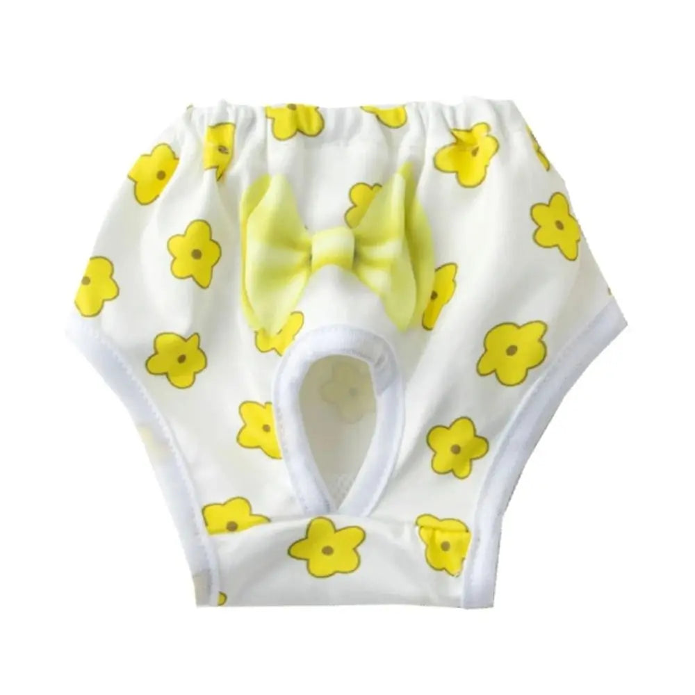 White reusable dog physiological pants with yellow flower patterns and a light yellow bow.