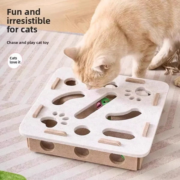 A light beige interactive cat puzzle toy with various holes and slots is being played with by a tabby cat.