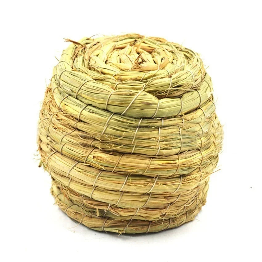 A tightly woven natural straw bird nest for pet avians, light yellow in color.