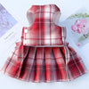 A red plaid pet dress-up harness and matching clothes for a dog displayed on a white background.