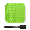 A bright green silicone lick mat for pets with suction cups and a black silicone spoon.