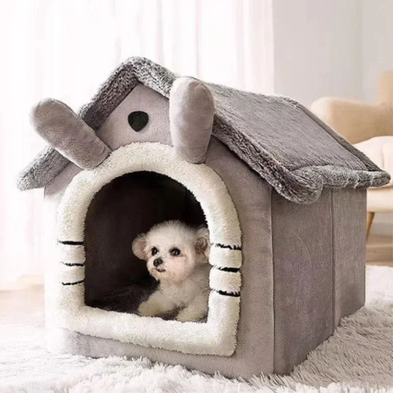 A gray pet house with a textured roof and entrance, featuring a small white puppy inside.