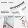 Close-up of a white pet slicker brush showing the V-shaped teeth and a skin fit painless knot opening.