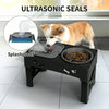 An ultrasonic seal dog bowl stand is shown with a dog eating from the bowl on a black platform.