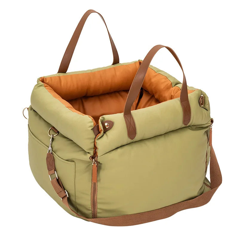 A olive green durable pet car seat with brown straps and a padded interior.