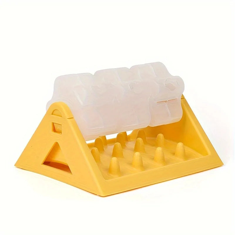 A yellow interactive dog food puzzle dispenser with a clear plastic food tray and feeding nozzles.