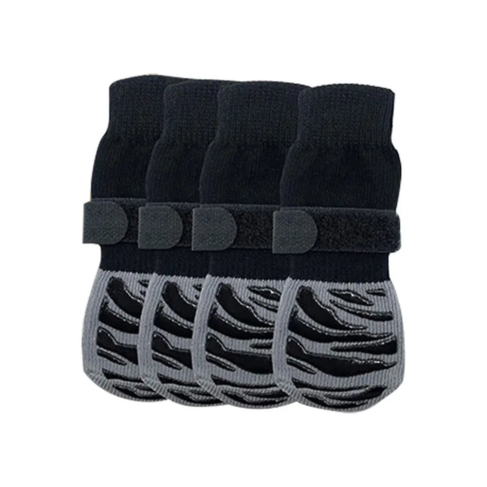 A set of black non-slip dog socks with extra-thick grips for protecting hardwood floors.