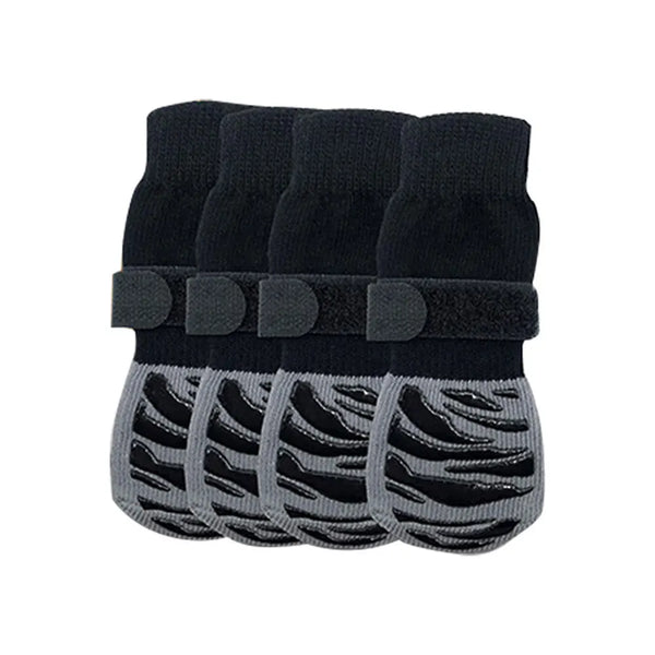 A set of black non-slip dog socks with extra-thick grips for protecting hardwood floors.
