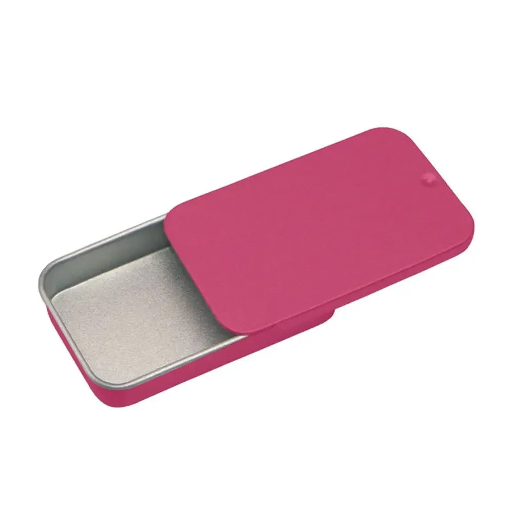 A pink compact sliding lid tin box with a silver interior, shown from an angle.