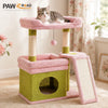 A pink cat tree with sisal scratching posts and green fabric perches for a kitten.