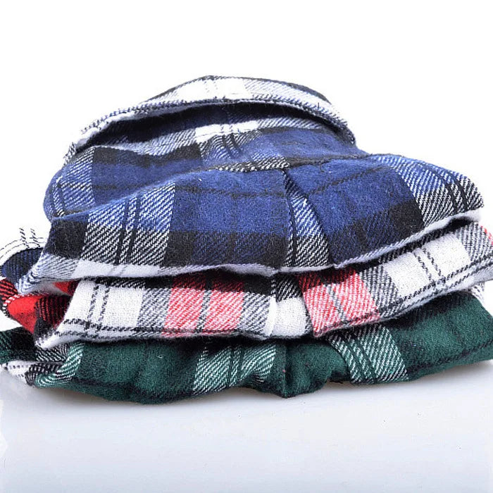 A stack of plaid button-up shirts in blue, black, white, and green fabric.