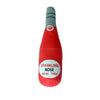 A red bottle-shaped squeaky plush dog toy with a gray tip and a paw print detail.