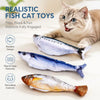 A tabby cat is interacting with realistic fish cat toys designed to engage the cat's instincts.