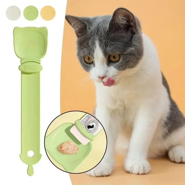 A domestic cat is shown next to a green long-handled pet food squeezer spoon, with an inset showing the tool's use.