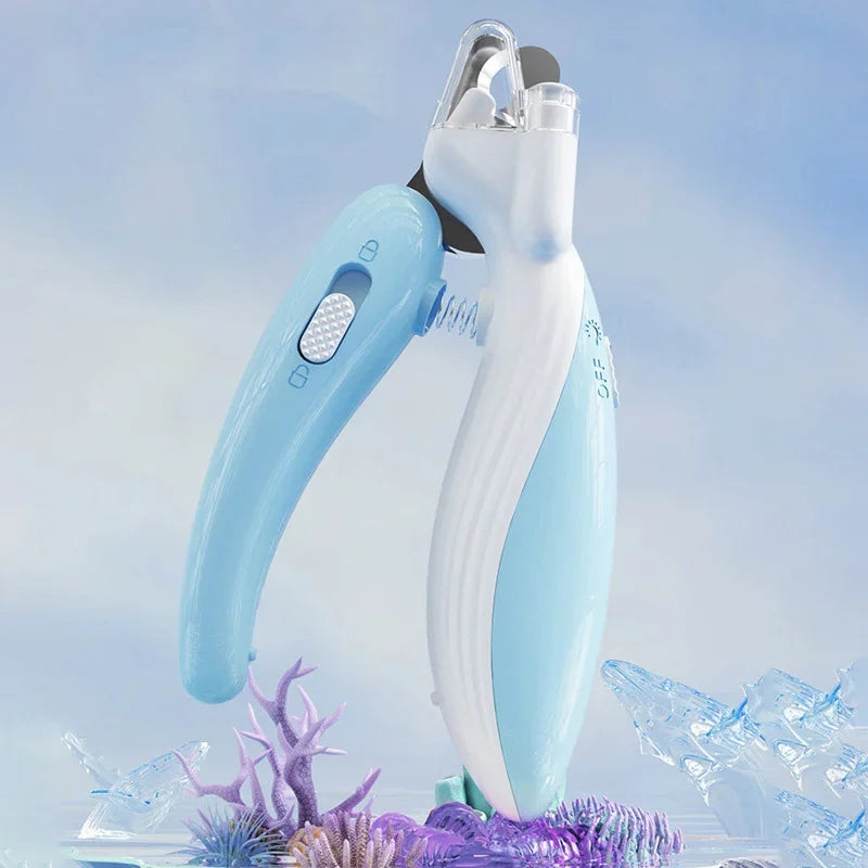 A light blue professional pet nail clipper is shown against a blurred background of ice and purple foliage.