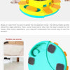 A hand is placing a piece of food into an interactive dog slow feeder puzzle toy for a dog.