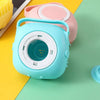 A light blue silicone pet bath massage brush with a foam maker is shown on a green surface.