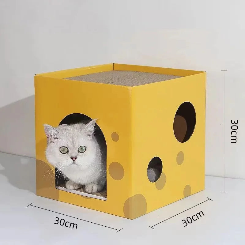 A yellow cardboard scratching house shaped like a cube with a cat face cutout and several circular holes.