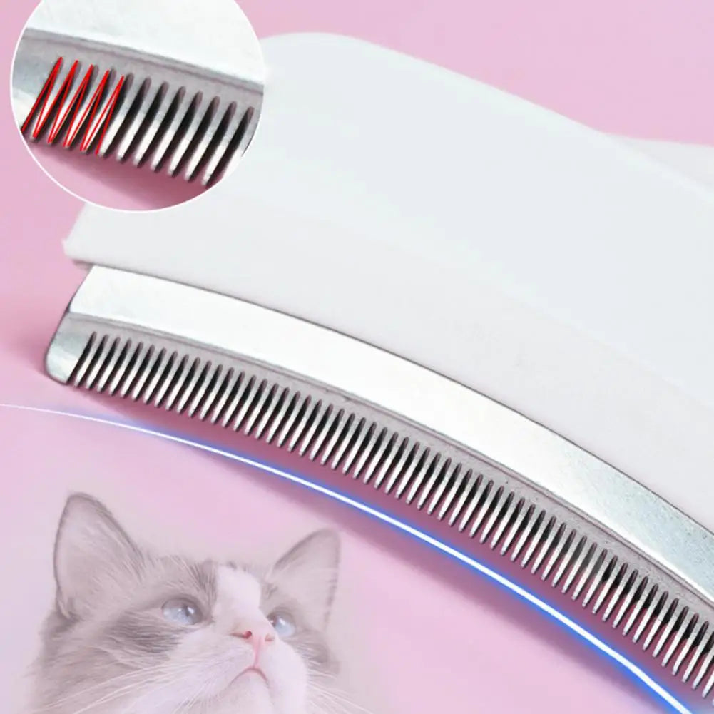 A close-up of a white grooming tool with a metal brush and a cat looking at it.