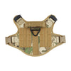 A tan tactical dog harness with a padded vest and Molle pouch system is shown from above.