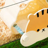 A light-colored cartoon hamster hideout house with a viewing window is shown resting on green grass.