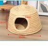 A round, woven straw mat with a circular entrance for small rodents, shown on a wooden surface.