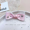 Pink bow hair accessory with white lace and rhinestone pearl accents