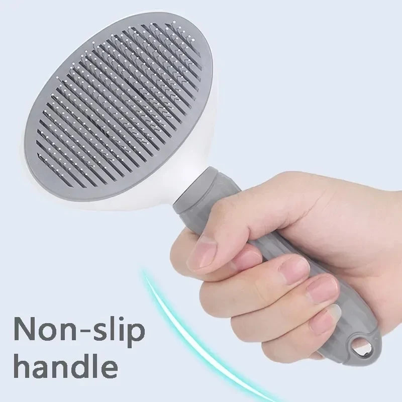 A hand is holding a gray pet hair remover grooming brush with a non-slip handle.