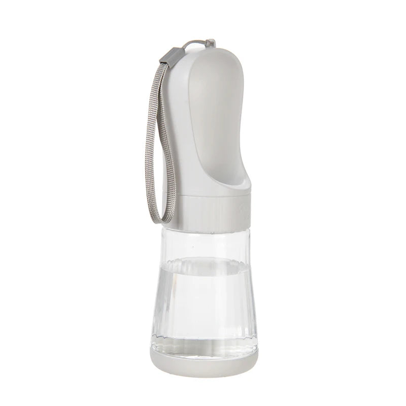 A white 2-in-1 portable pet water and food dispenser with a clear reservoir and a silicone strap.