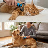 A woman is using a dual-sided pet deshedding rake brush on a golden retriever dog.